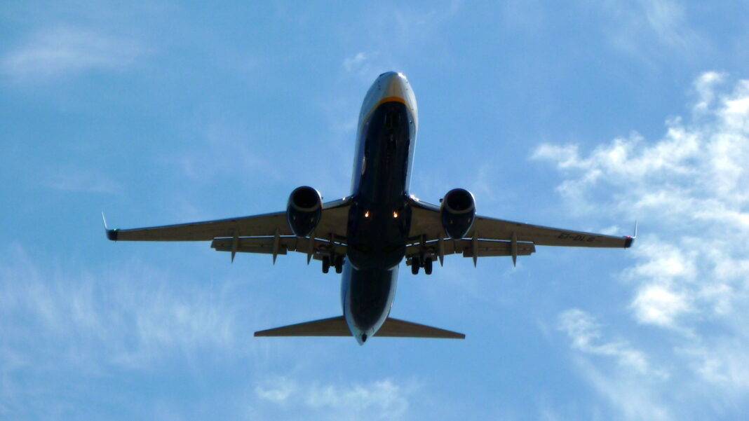 Airplane in flight against a blue sky.