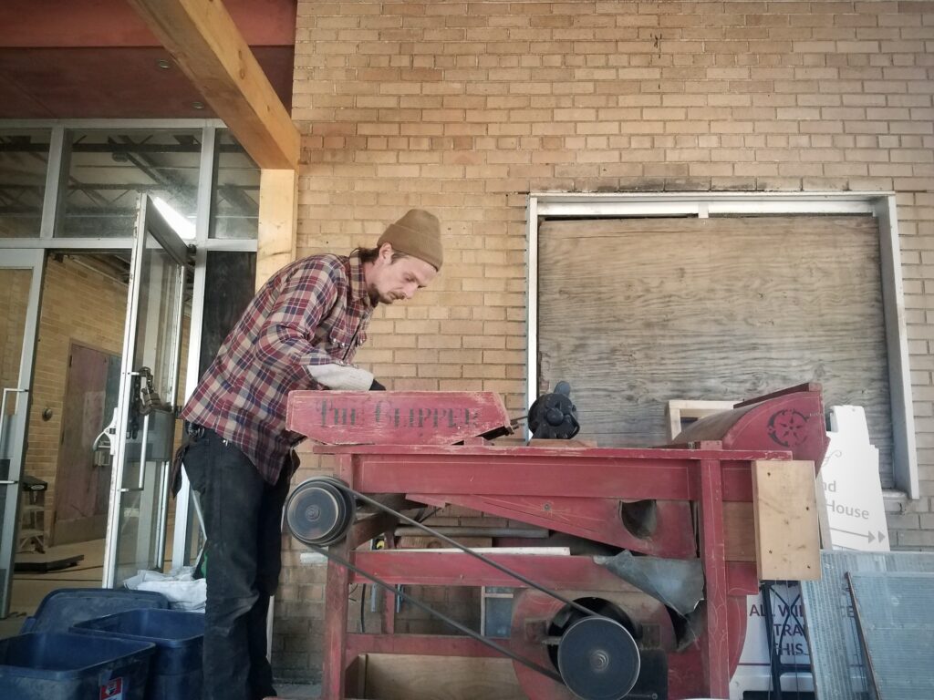 Man running rice machine.